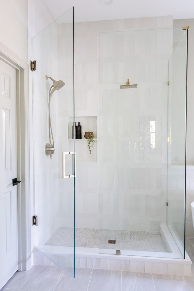 This is an example of a medium sized modern ensuite bathroom in Dallas with freestanding cabinets, light wood cabinets, a freestanding bath, a double shower, a one-piece toilet, green tiles, metro tiles, green walls, ceramic flooring, a submerged sink, quartz worktops, multi-coloured floors, a hinged door, white worktops, a wall niche and a built in vanity unit.