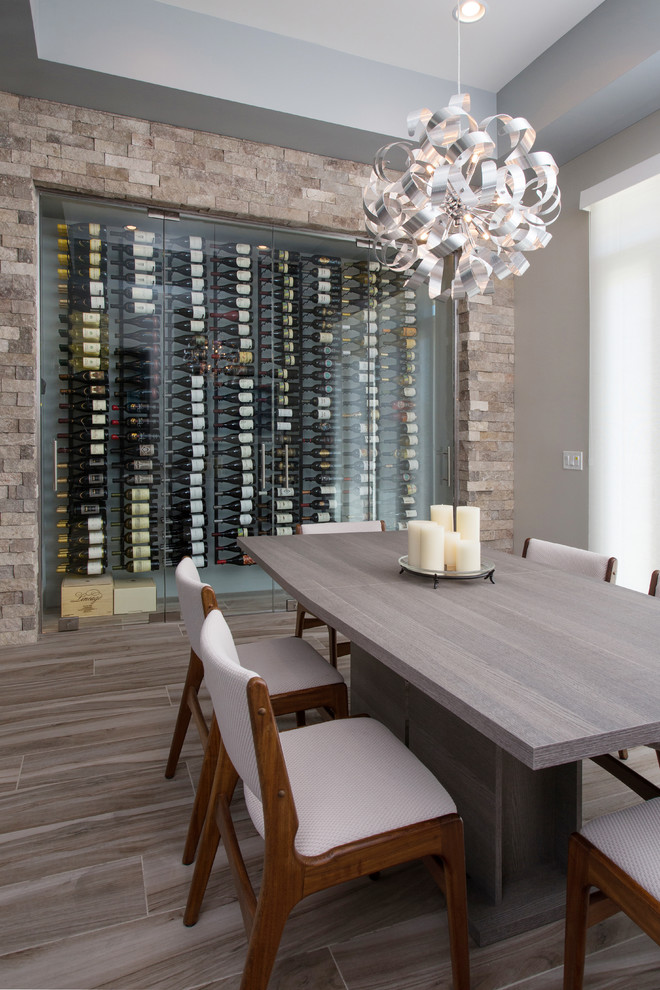 Design ideas for a small contemporary wine cellar in Los Angeles with medium hardwood floors and display racks.