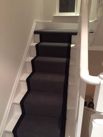 Inspiration for a mid-sized traditional carpeted u-shaped staircase in London with carpet risers.