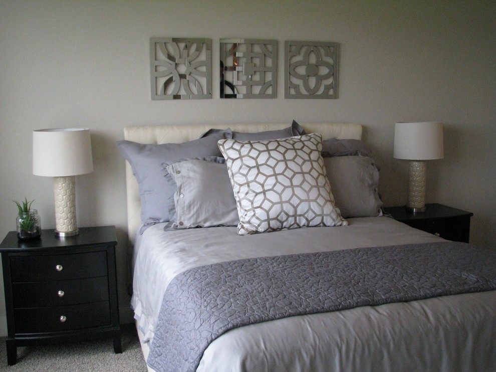 This is an example of a mid-sized transitional guest bedroom in Denver with beige walls, carpet, no fireplace and grey floor.