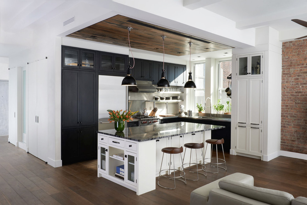 Inspiration for a large transitional l-shaped open plan kitchen in New York with shaker cabinets, black cabinets, quartzite benchtops, stainless steel appliances, medium hardwood floors, an integrated sink, white splashback, ceramic splashback and with island.