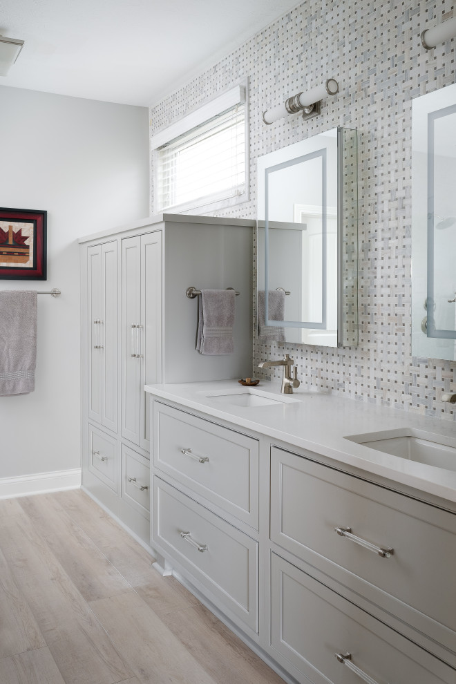 Mid-sized arts and crafts master wet room bathroom in Indianapolis with shaker cabinets, beige cabinets, light hardwood floors, an undermount sink, engineered quartz benchtops, a hinged shower door, white benchtops, a double vanity and a built-in vanity.