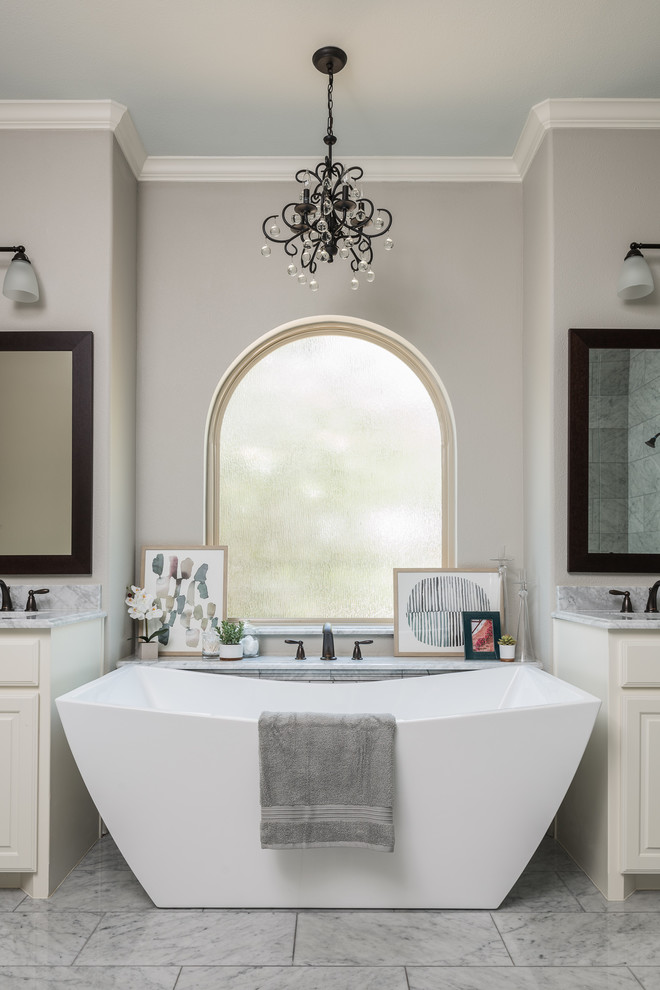 Inspiration for a large country master wet room bathroom in Dallas with recessed-panel cabinets, white cabinets, a freestanding tub, a one-piece toilet, gray tile, grey walls, marble floors, an undermount sink, marble benchtops, grey floor, a hinged shower door and grey benchtops.