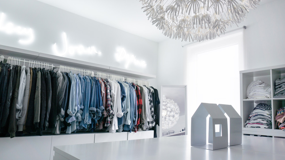 Photo of a modern women's walk-in wardrobe in Other with open cabinets and white cabinets.