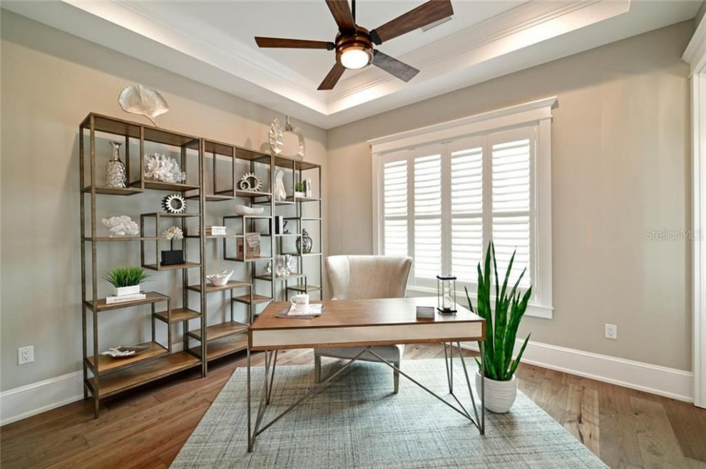 Inspiration for a beach style home office in Tampa with beige walls, medium hardwood floors and brown floor.