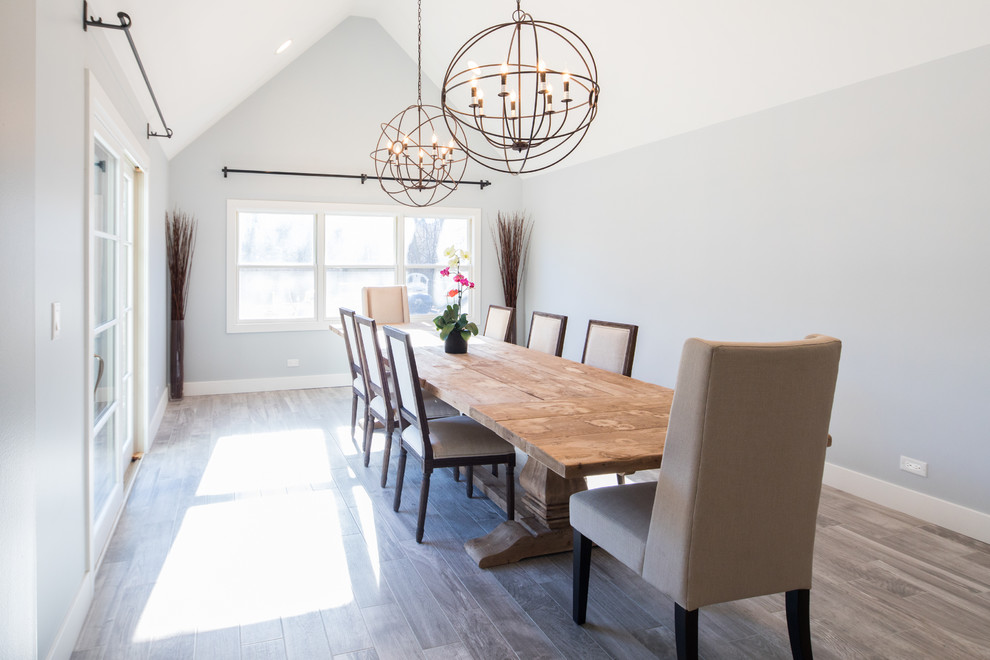 Design ideas for a large transitional separate dining room in Chicago with grey walls, porcelain floors and brown floor.