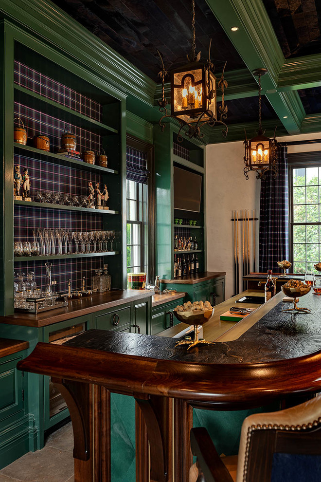 This is an example of a traditional home bar in New York with a drop-in sink, raised-panel cabinets, green cabinets, multi-coloured splashback and grey floor.