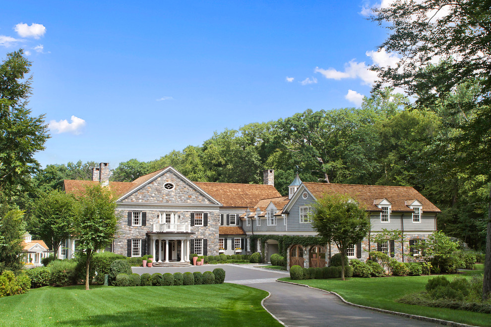 Traditional two-storey grey exterior in New York with mixed siding and a gable roof.