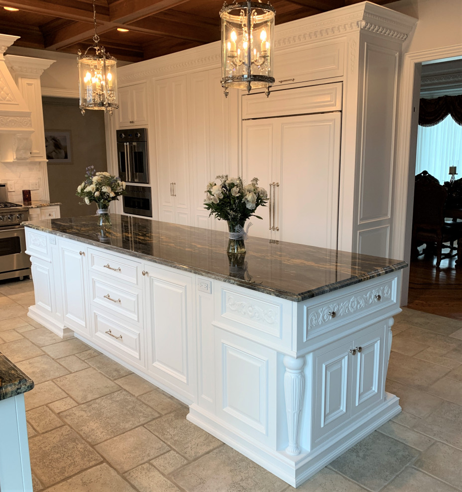 Photo of a large traditional u-shaped eat-in kitchen in New York with a farmhouse sink, raised-panel cabinets, white cabinets, marble benchtops, white splashback, window splashback, stainless steel appliances, ceramic floors, with island, beige floor and multi-coloured benchtop.