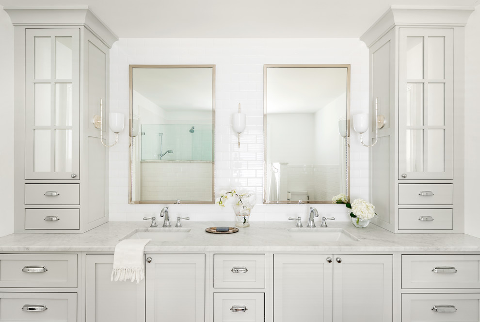 This is an example of a mid-sized traditional master bathroom in Other with recessed-panel cabinets, grey cabinets, a corner shower, a one-piece toilet, white tile, subway tile, white walls, an undermount sink, marble benchtops, an open shower and white benchtops.
