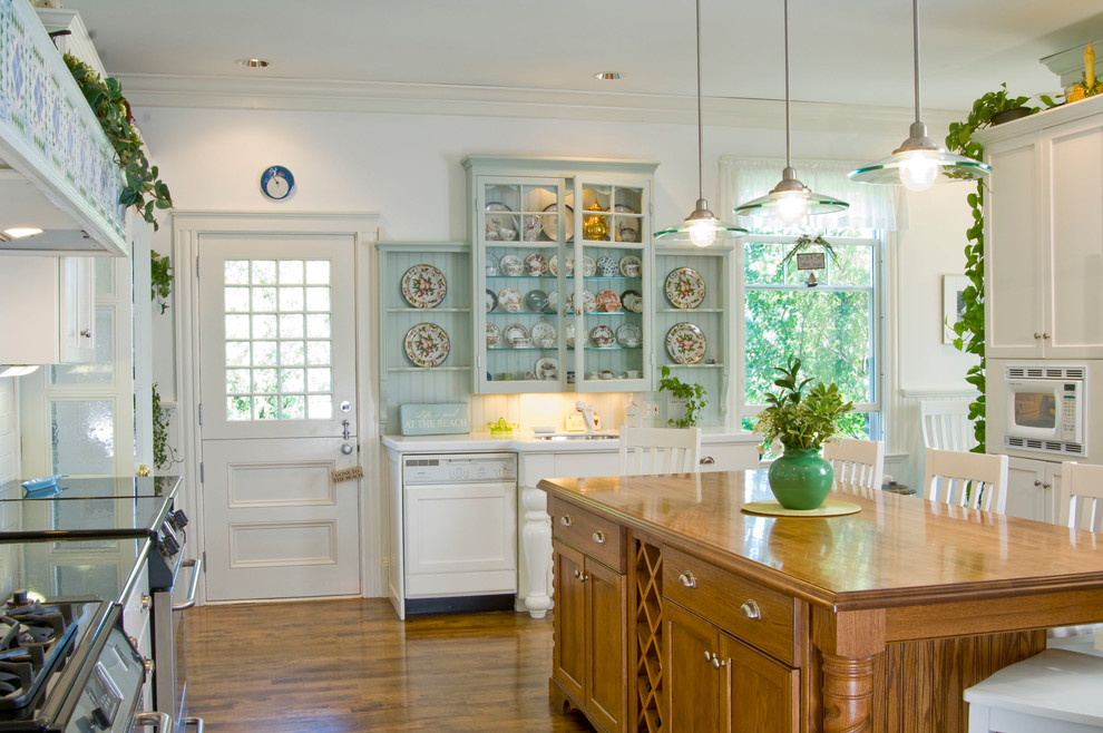 This is an example of a large traditional separate kitchen in Boston with shaker cabinets, white cabinets, marble benchtops, medium hardwood floors, with island, an undermount sink, white splashback, subway tile splashback and stainless steel appliances.