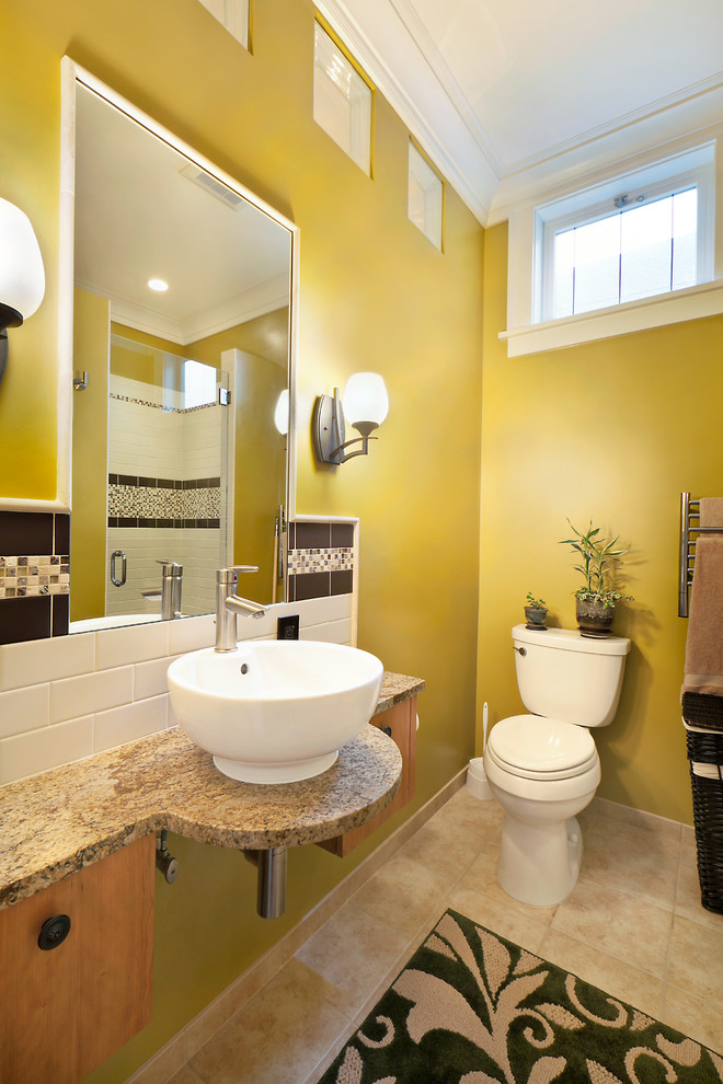 This is an example of a traditional bathroom in Seattle with a vessel sink, granite benchtops, a two-piece toilet, multi-coloured tile and ceramic tile.