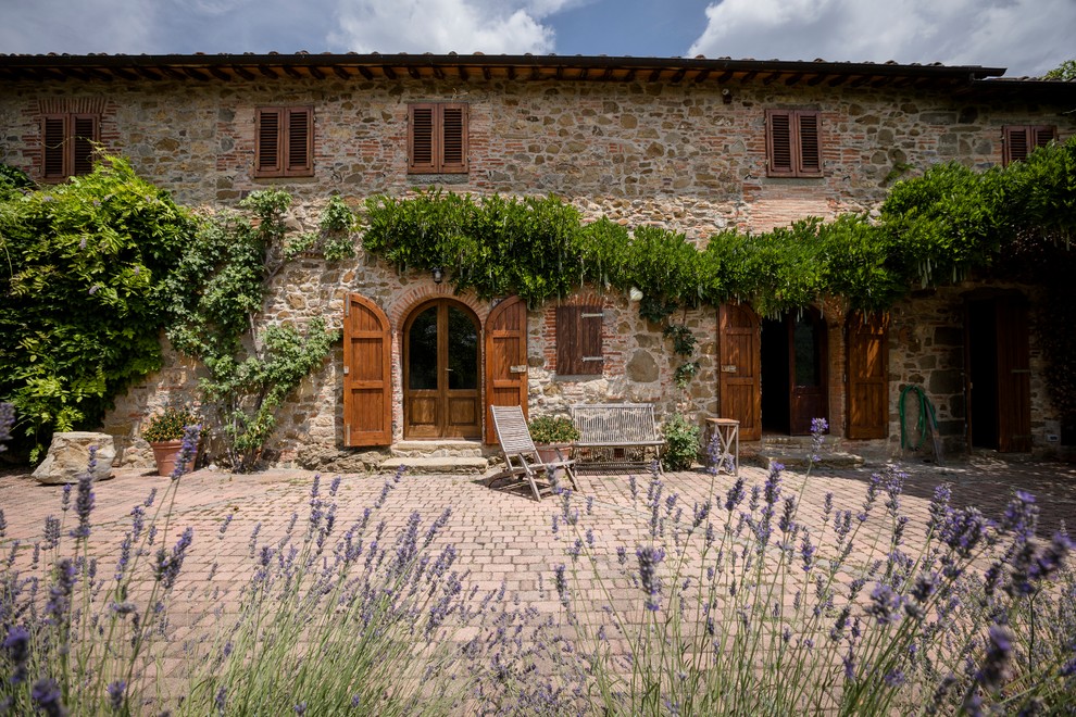 Inspiration for a mediterranean patio in Florence with brick pavers and no cover.