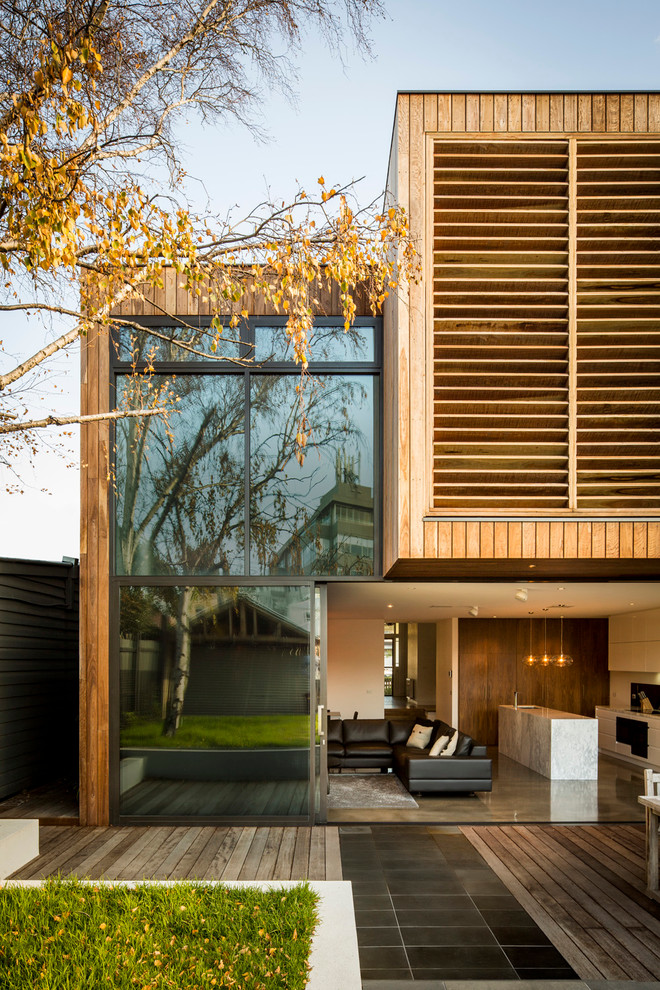 This is an example of a mid-sized contemporary two-storey exterior in Melbourne with wood siding.