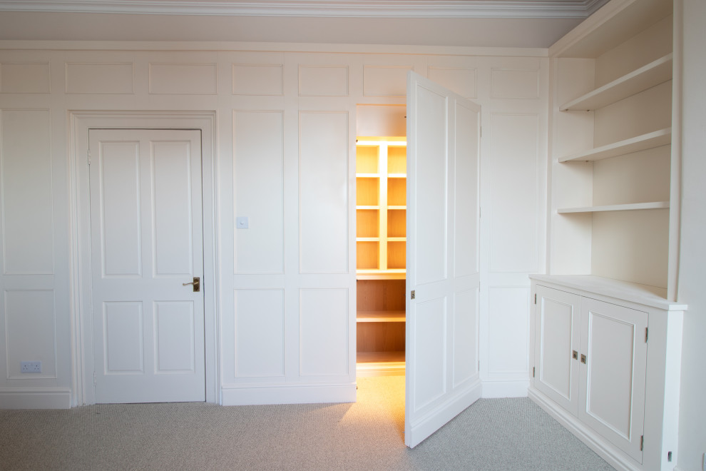 This is an example of a mid-sized traditional home office in Cheshire with beige walls, carpet and beige floor.