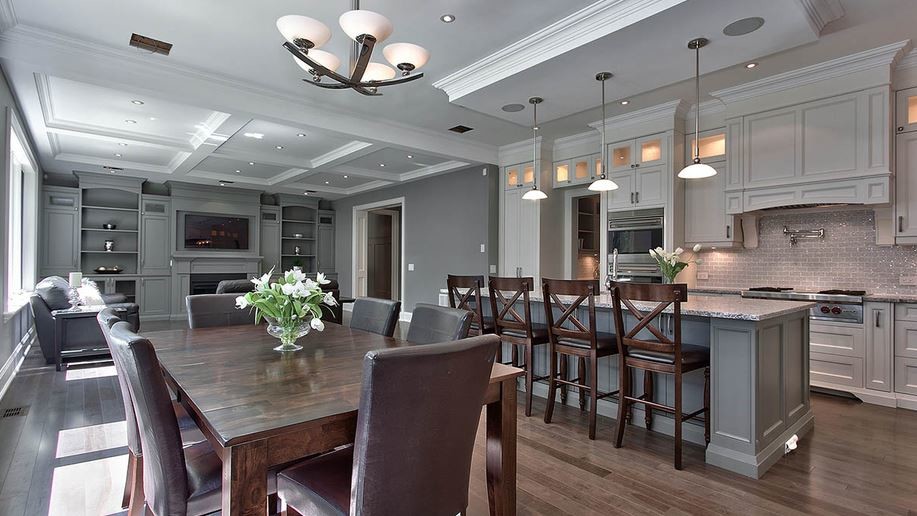 Inspiration for a mid-sized transitional l-shaped dark wood floor open concept kitchen remodel in Toronto with a double-bowl sink, shaker cabinets, white cabinets, granite countertops, gray backsplash, subway tile backsplash, stainless steel appliances and an island