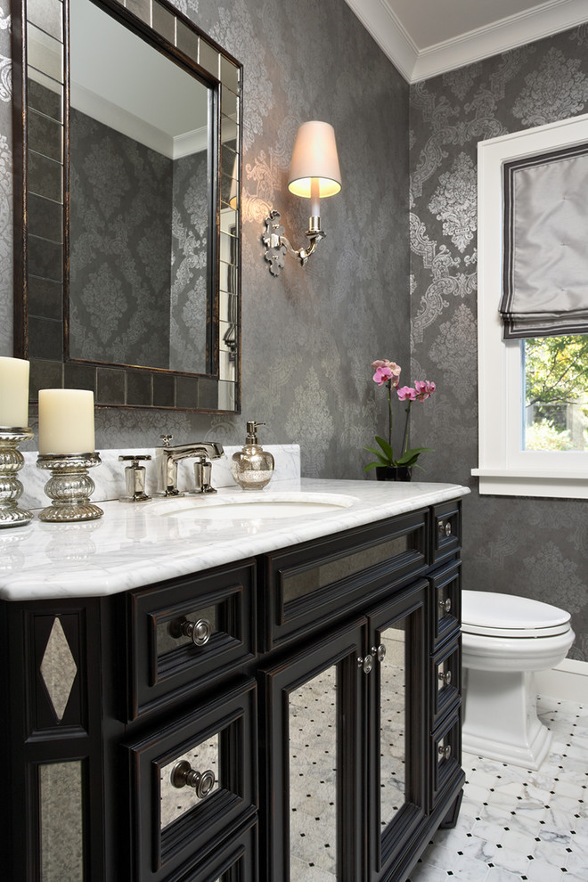 Design ideas for a traditional powder room in Minneapolis with an undermount sink, recessed-panel cabinets, black cabinets and white benchtops.