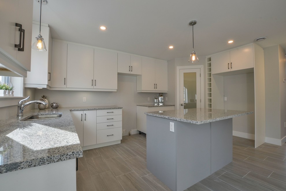 Mid-sized transitional ceramic tile and gray floor eat-in kitchen photo with an undermount sink, flat-panel cabinets, white cabinets, granite countertops, an island and gray countertops
