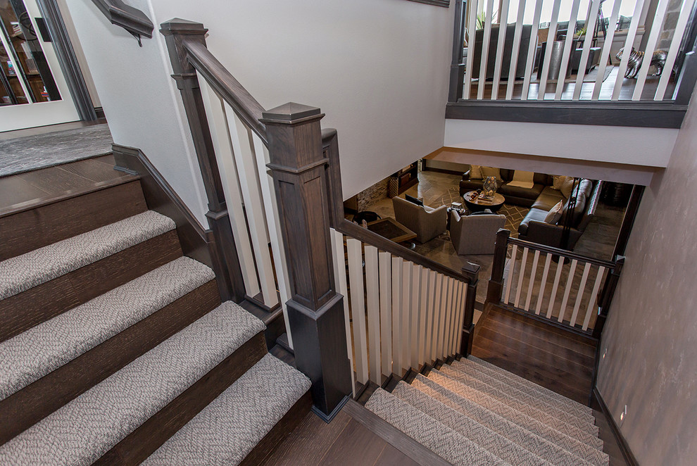 Mid-sized transitional carpeted l-shaped staircase in Other with wood risers and wood railing.