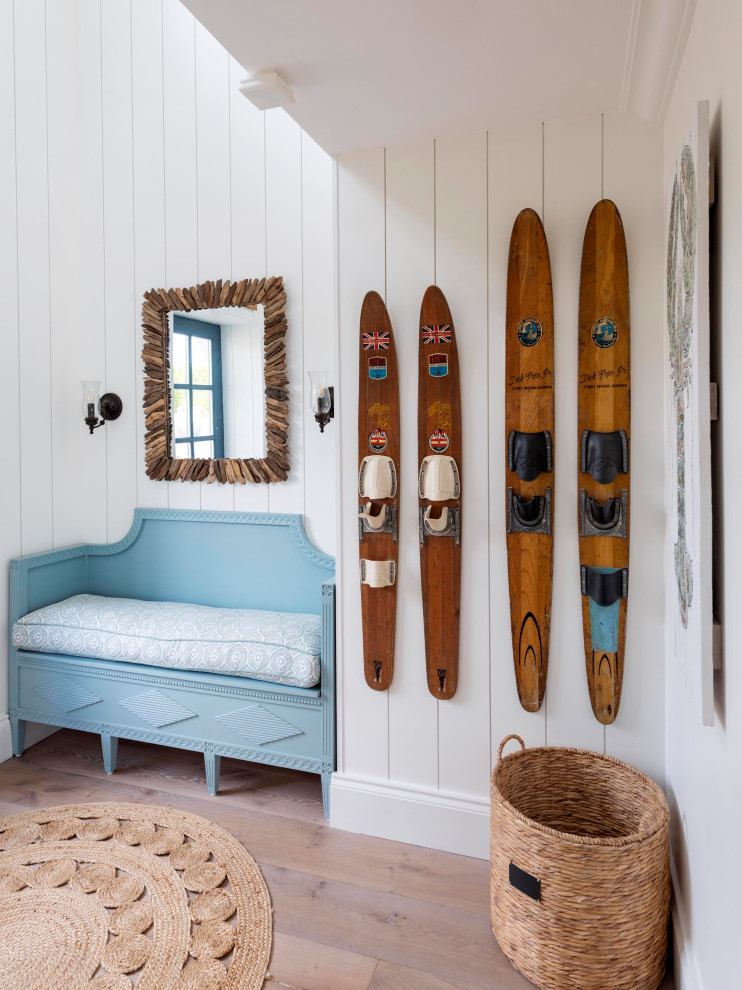 Large beach style entry hall in Devon with yellow walls, medium hardwood floors, a single front door, a blue front door, brown floor, timber and panelled walls.