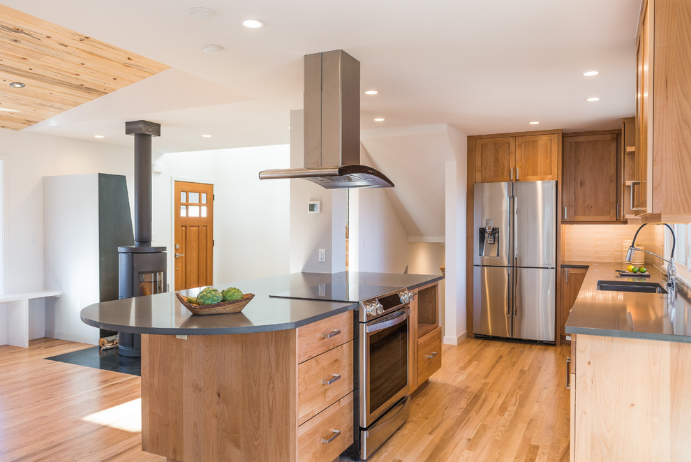 Eat-in kitchen - mid-sized modern l-shaped light wood floor eat-in kitchen idea in Denver with an integrated sink, recessed-panel cabinets, light wood cabinets, beige backsplash, ceramic backsplash, stainless steel appliances and an island