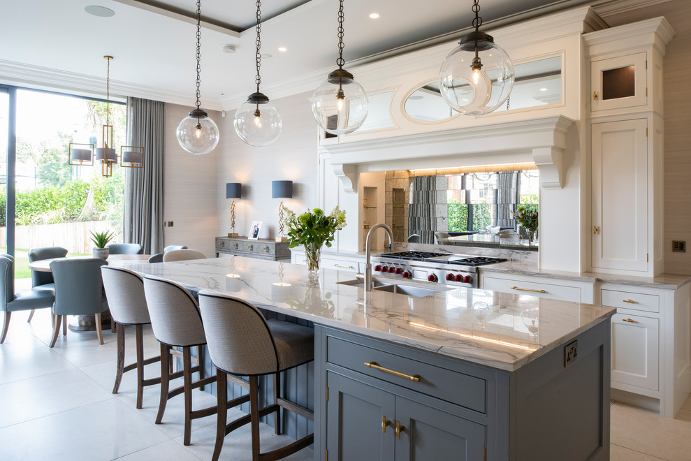 Traditional eat-in kitchen in London with shaker cabinets, white cabinets, with island, a double-bowl sink, mirror splashback, stainless steel appliances, white floor and white benchtop.