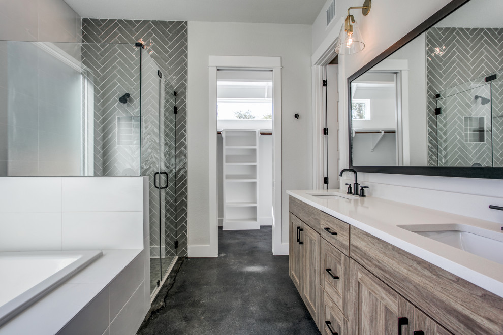 Photo of a mid-sized modern master bathroom in Austin with recessed-panel cabinets, brown cabinets, a drop-in tub, a curbless shower, a two-piece toilet, gray tile, porcelain tile, white walls, concrete floors, an undermount sink, engineered quartz benchtops, grey floor, a hinged shower door, white benchtops, a double vanity and a built-in vanity.