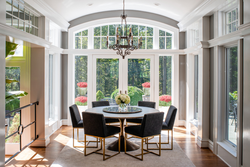 Design ideas for a large transitional dining room in DC Metro with medium hardwood floors, grey walls and brown floor.