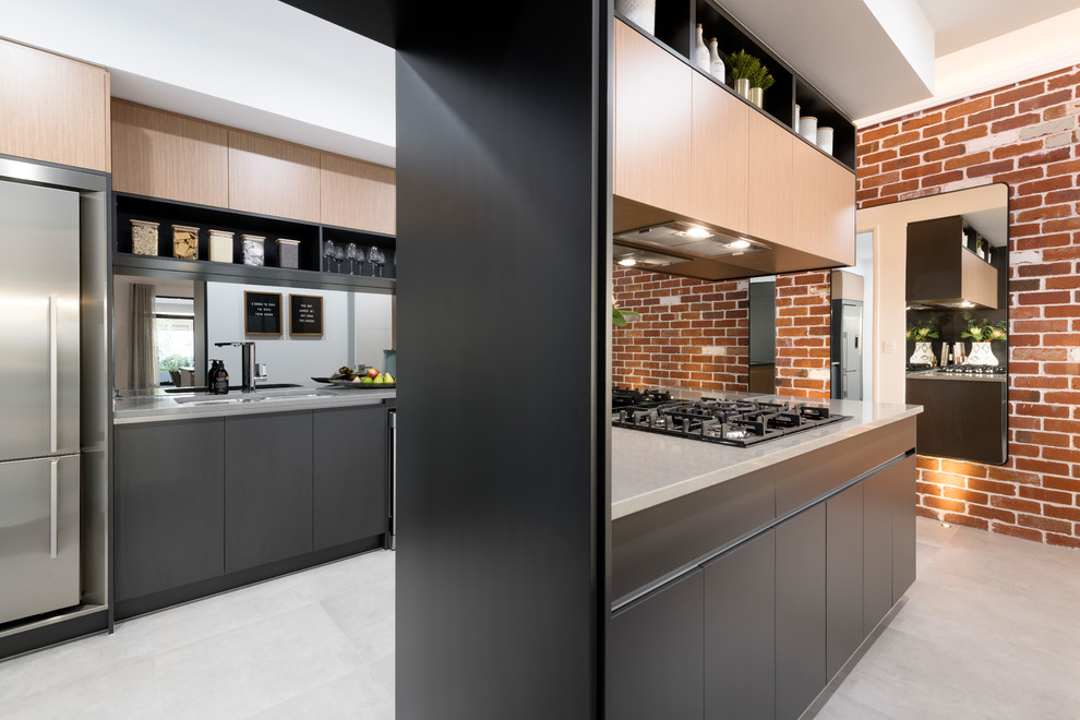 Inspiration for a mid-sized contemporary galley open plan kitchen in Perth with a double-bowl sink, black cabinets, solid surface benchtops, mirror splashback, stainless steel appliances, ceramic floors, grey floor and grey benchtop.