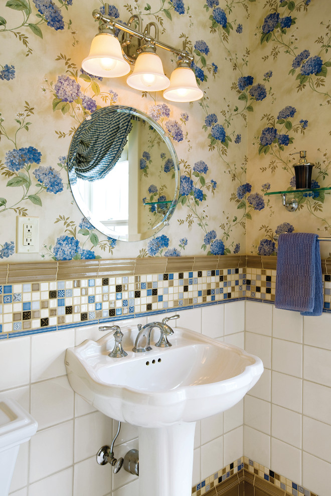 This is an example of a traditional powder room in Cleveland with a pedestal sink, multi-coloured tile and mosaic tile.