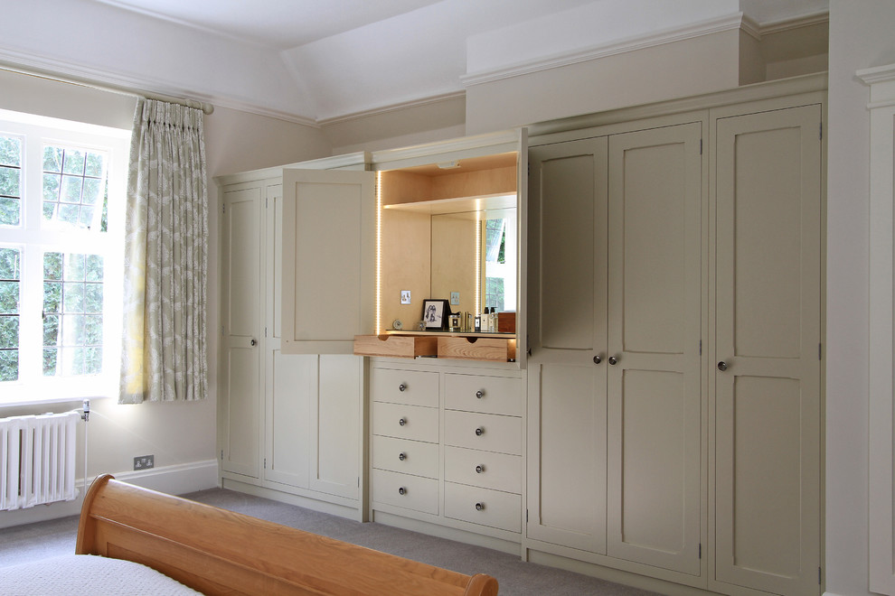 Design ideas for a large traditional storage and wardrobe in Hampshire with carpet.