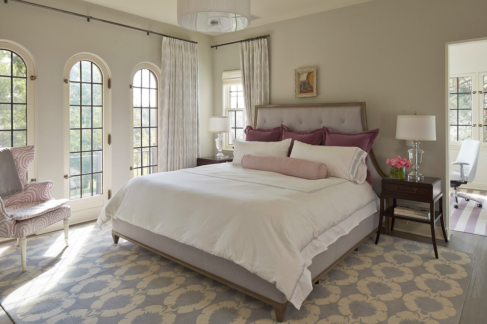 This is an example of a transitional master bedroom in Minneapolis.