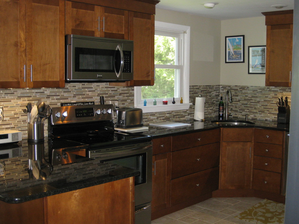 Transitional u-shaped travertine floor and beige floor eat-in kitchen photo in Boston with an undermount sink, medium tone wood cabinets, granite countertops, stainless steel appliances, a peninsula, shaker cabinets, brown backsplash, matchstick tile backsplash and black countertops