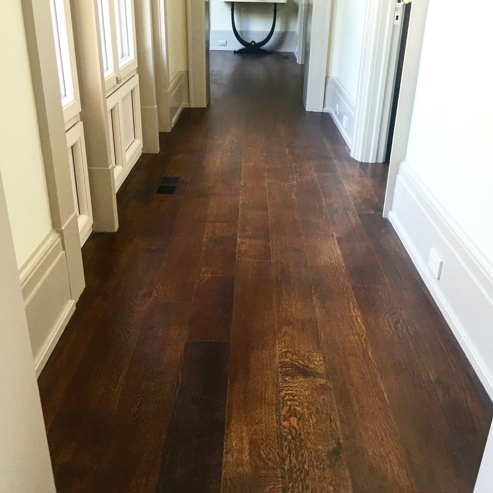 Design ideas for an expansive country hallway in New York with beige walls and dark hardwood floors.