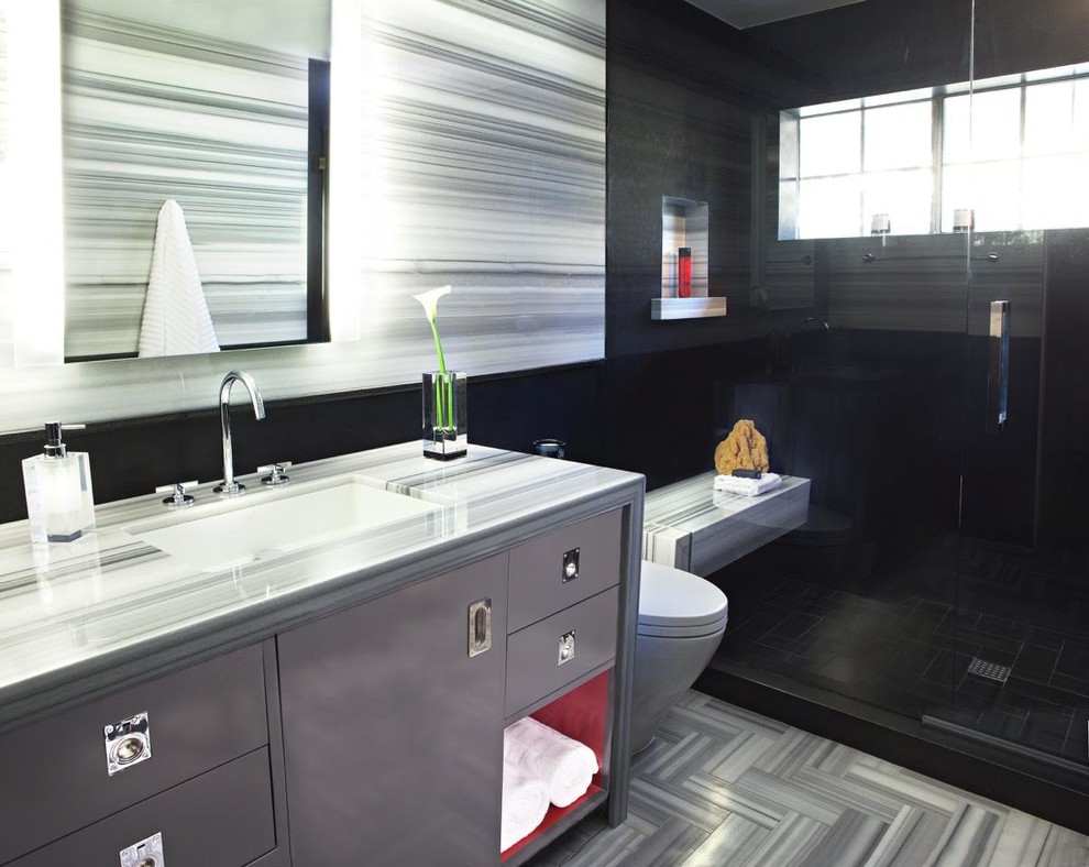 This is an example of a mid-sized contemporary master bathroom in Los Angeles with flat-panel cabinets, grey cabinets, a one-piece toilet, black and white tile, marble floors, an undermount sink, marble benchtops, an alcove shower and grey walls.