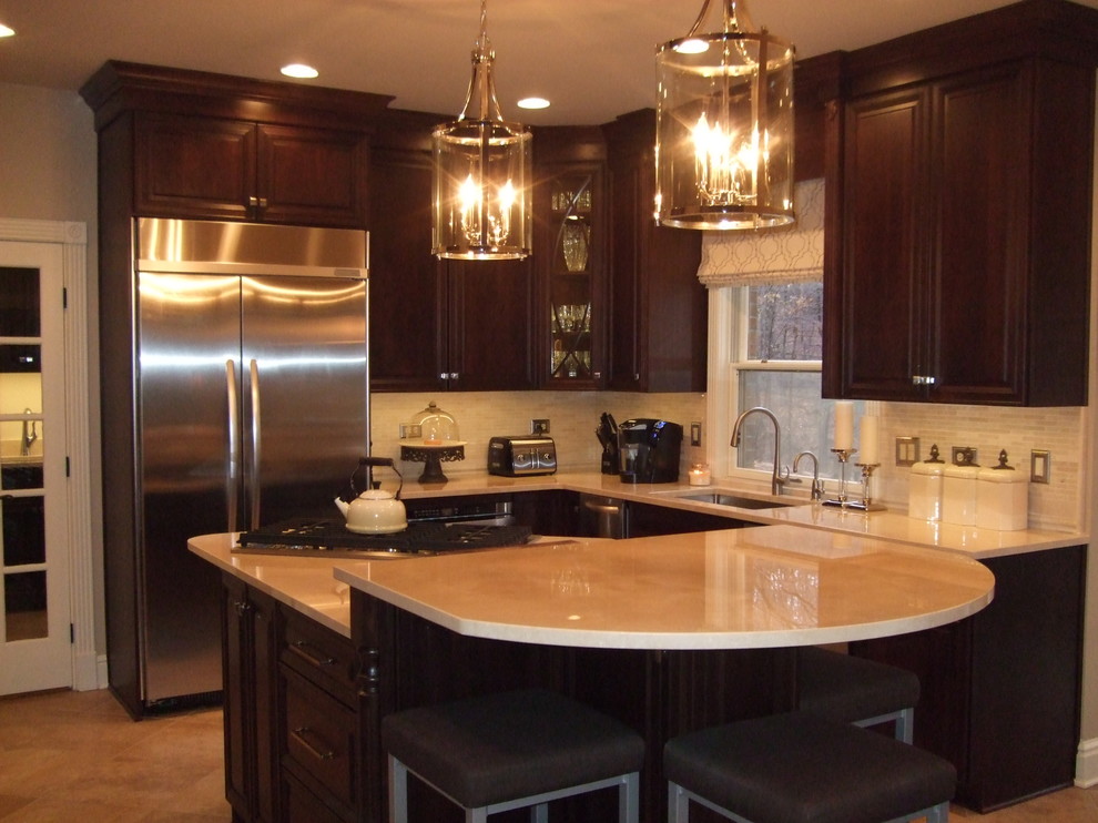 Large transitional kitchen photo with a single-bowl sink, raised-panel cabinets, dark wood cabinets, marble countertops, stainless steel appliances and an island