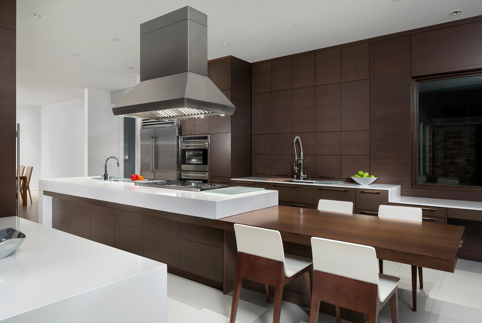 Large modern galley eat-in kitchen in Chicago with a single-bowl sink, flat-panel cabinets, medium wood cabinets, solid surface benchtops, stainless steel appliances, porcelain floors and with island.