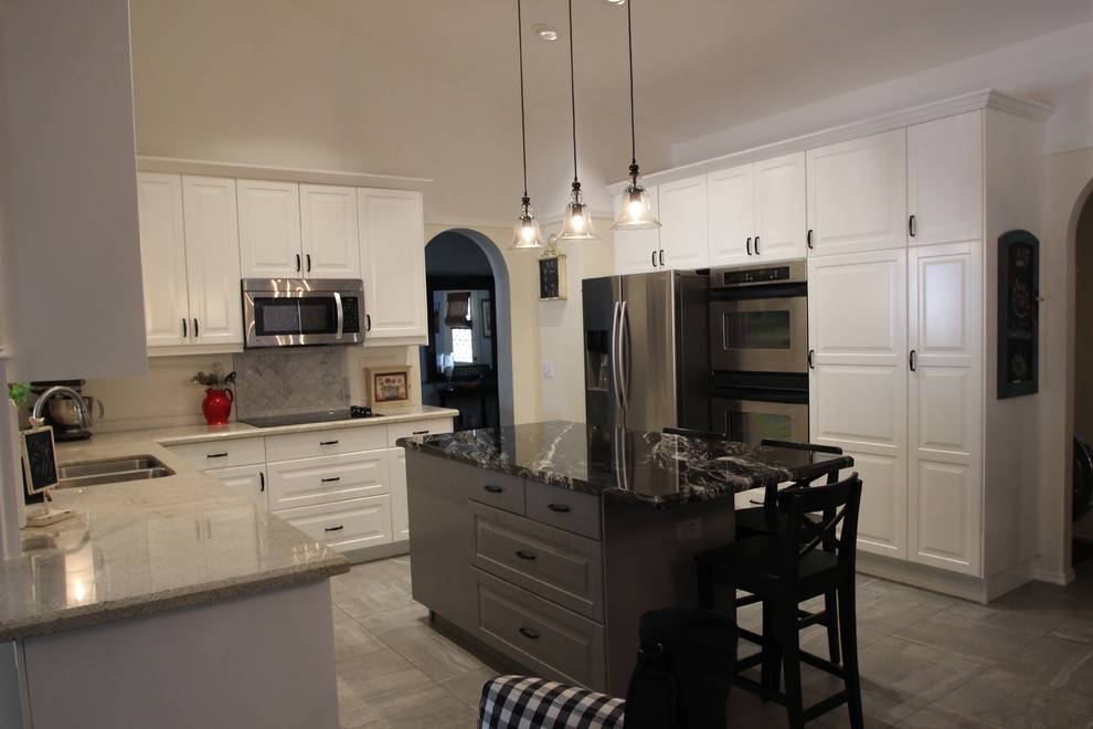 Example of a mid-sized transitional u-shaped ceramic tile enclosed kitchen design in Phoenix with a double-bowl sink, raised-panel cabinets, white cabinets, marble countertops, gray backsplash, ceramic backsplash, stainless steel appliances and an island