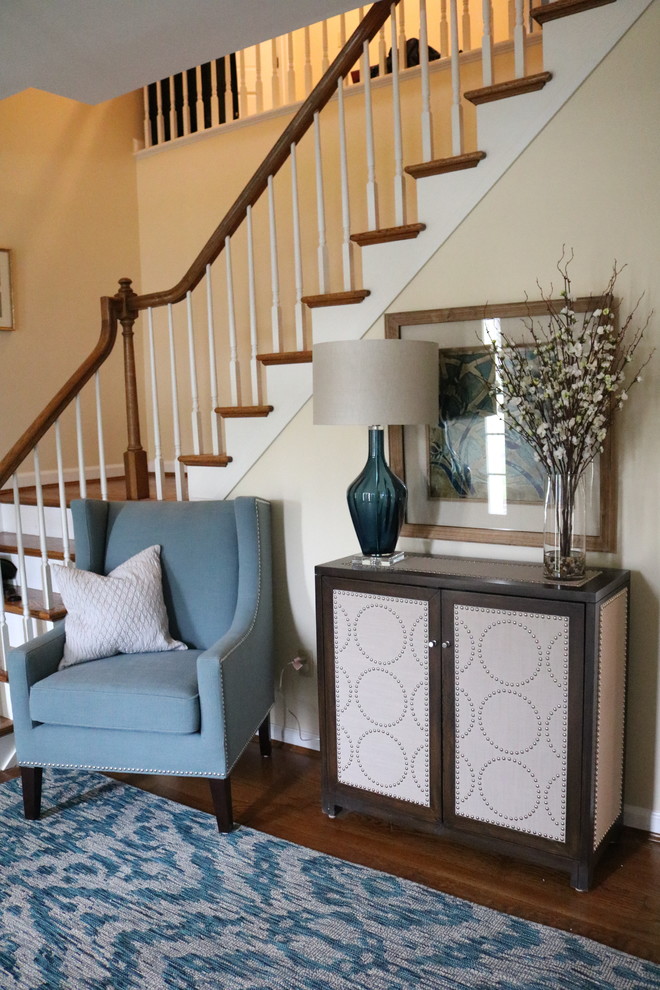 Small transitional medium tone wood floor foyer photo in Cincinnati with yellow walls