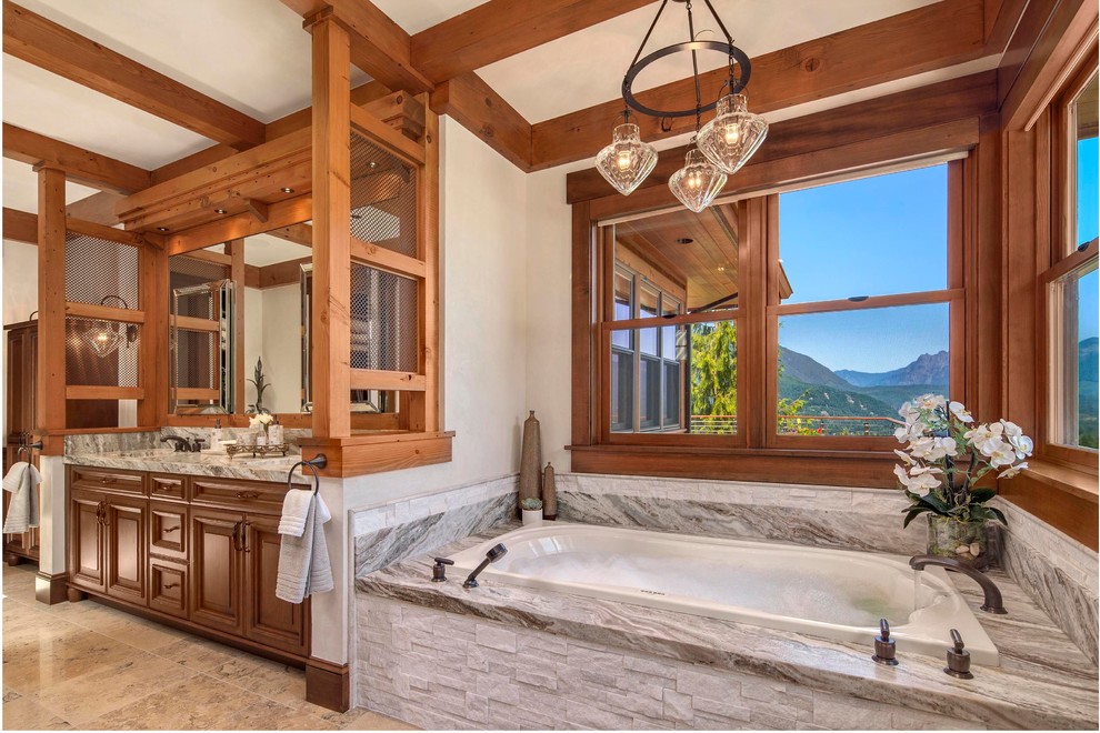 Inspiration for a country bathroom in Other with an undermount sink, raised-panel cabinets, medium wood cabinets, a drop-in tub and white walls.