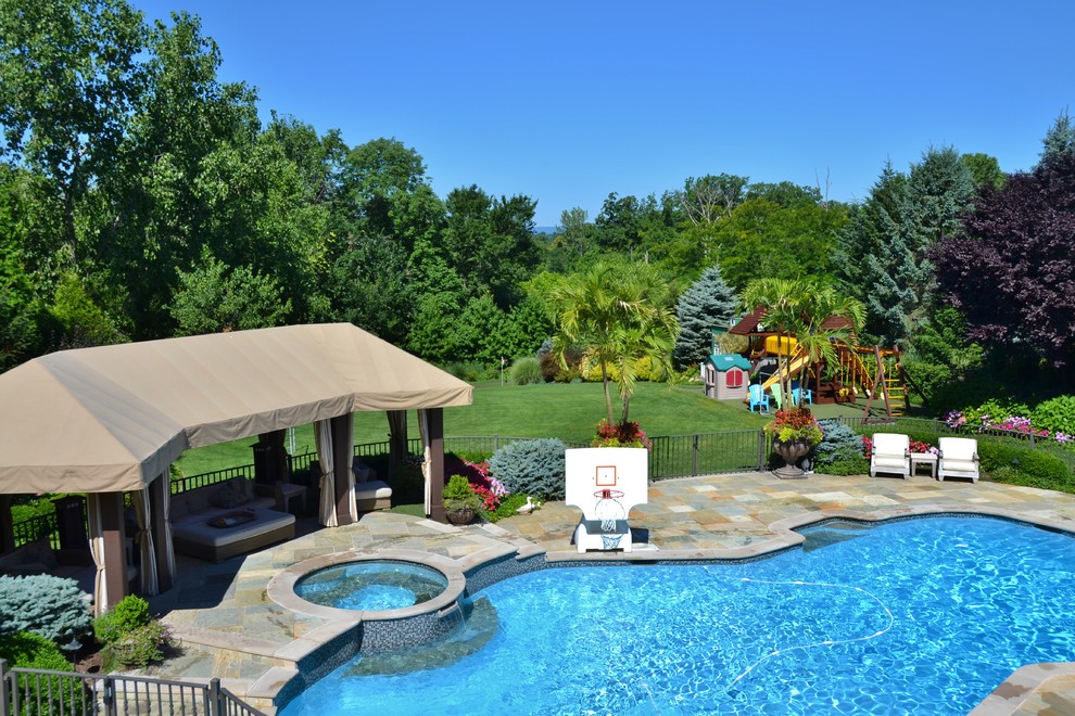 Design ideas for a large traditional backyard custom-shaped natural pool in Newark.