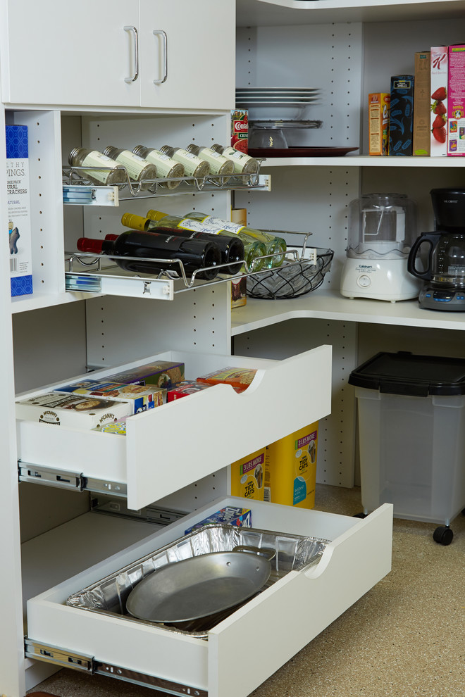 This is an example of a mid-sized traditional kitchen pantry in Philadelphia with flat-panel cabinets, white cabinets, white splashback and carpet.
