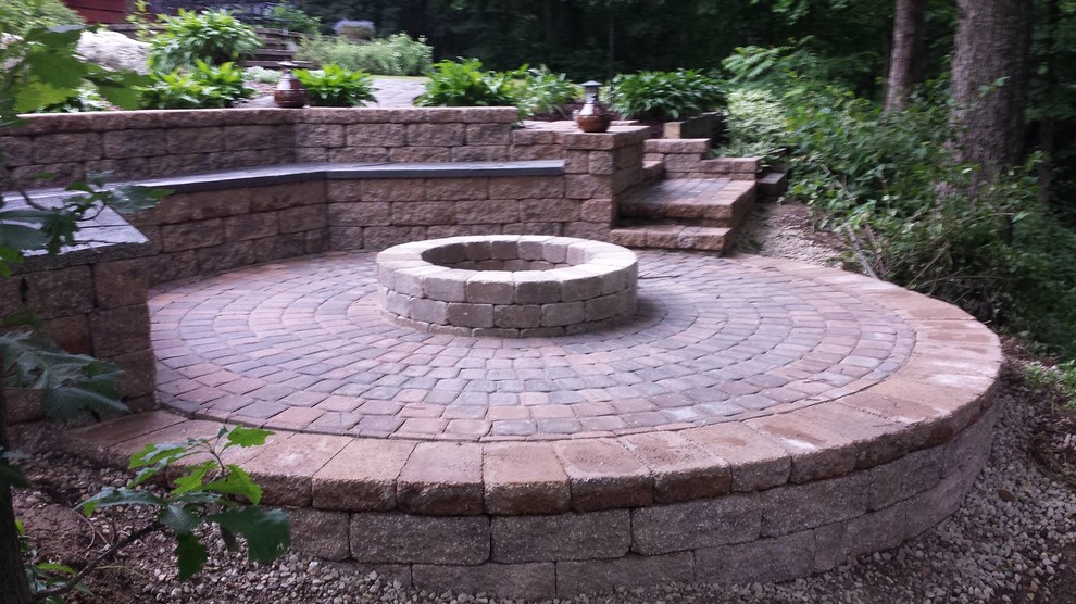 Design ideas for a backyard patio in Minneapolis with a fire feature and brick pavers.