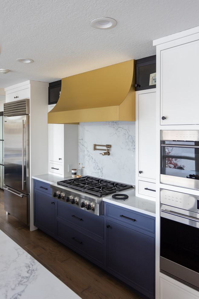 Example of a large transitional galley brown floor and dark wood floor eat-in kitchen design in Cleveland with an undermount sink, quartzite countertops, white backsplash, stainless steel appliances, an island, white countertops and shaker cabinets