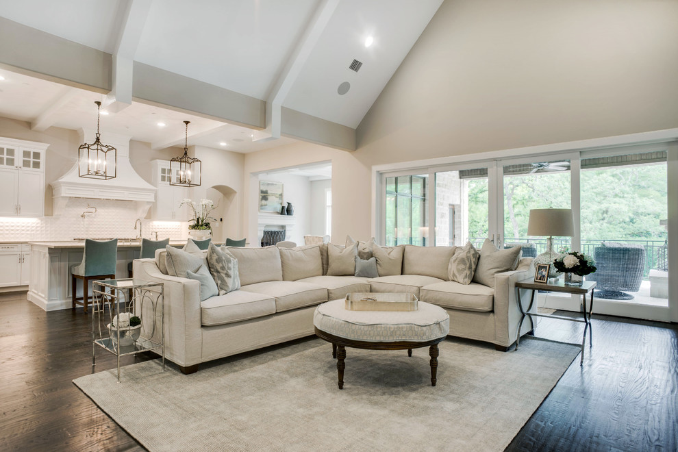 Design ideas for a large transitional open concept family room in Dallas with grey walls, a standard fireplace, a built-in media wall and brown floor.