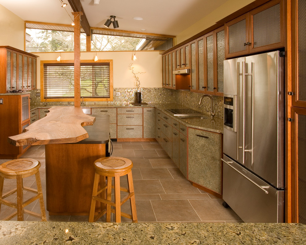 This is an example of a large asian u-shaped separate kitchen in Seattle with an undermount sink, glass-front cabinets, medium wood cabinets, granite benchtops, multi-coloured splashback, mosaic tile splashback, stainless steel appliances, porcelain floors, with island and brown floor.