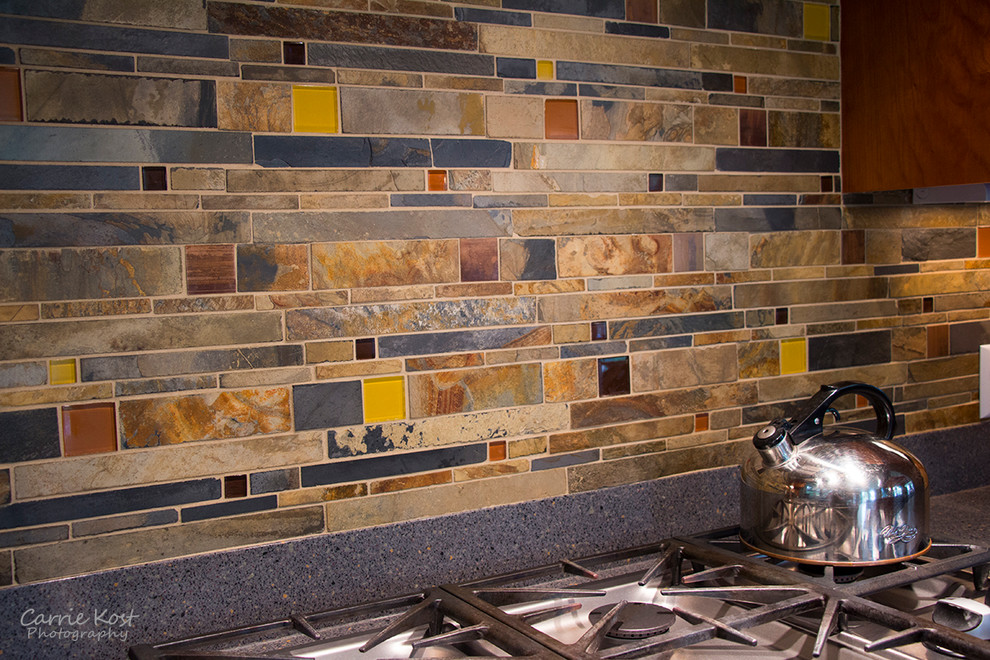 Open concept kitchen - mid-sized transitional l-shaped open concept kitchen idea in Milwaukee with an island, shaker cabinets, medium tone wood cabinets, quartzite countertops, multicolored backsplash, mosaic tile backsplash and stainless steel appliances
