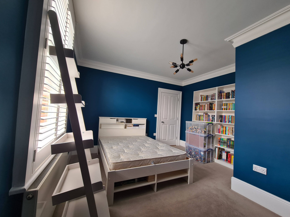 Design ideas for a large traditional master bedroom in London with blue walls, carpet, beige floor and recessed.