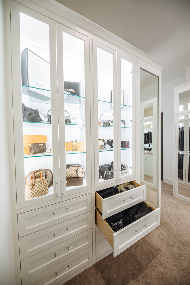 Photo of a large transitional gender-neutral walk-in wardrobe in Dallas with beaded inset cabinets, white cabinets, carpet and beige floor.