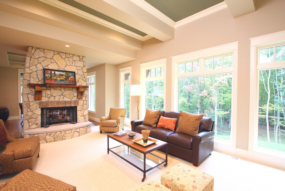 Photo of a traditional living room in Grand Rapids with beige walls, a standard fireplace and a stone fireplace surround.